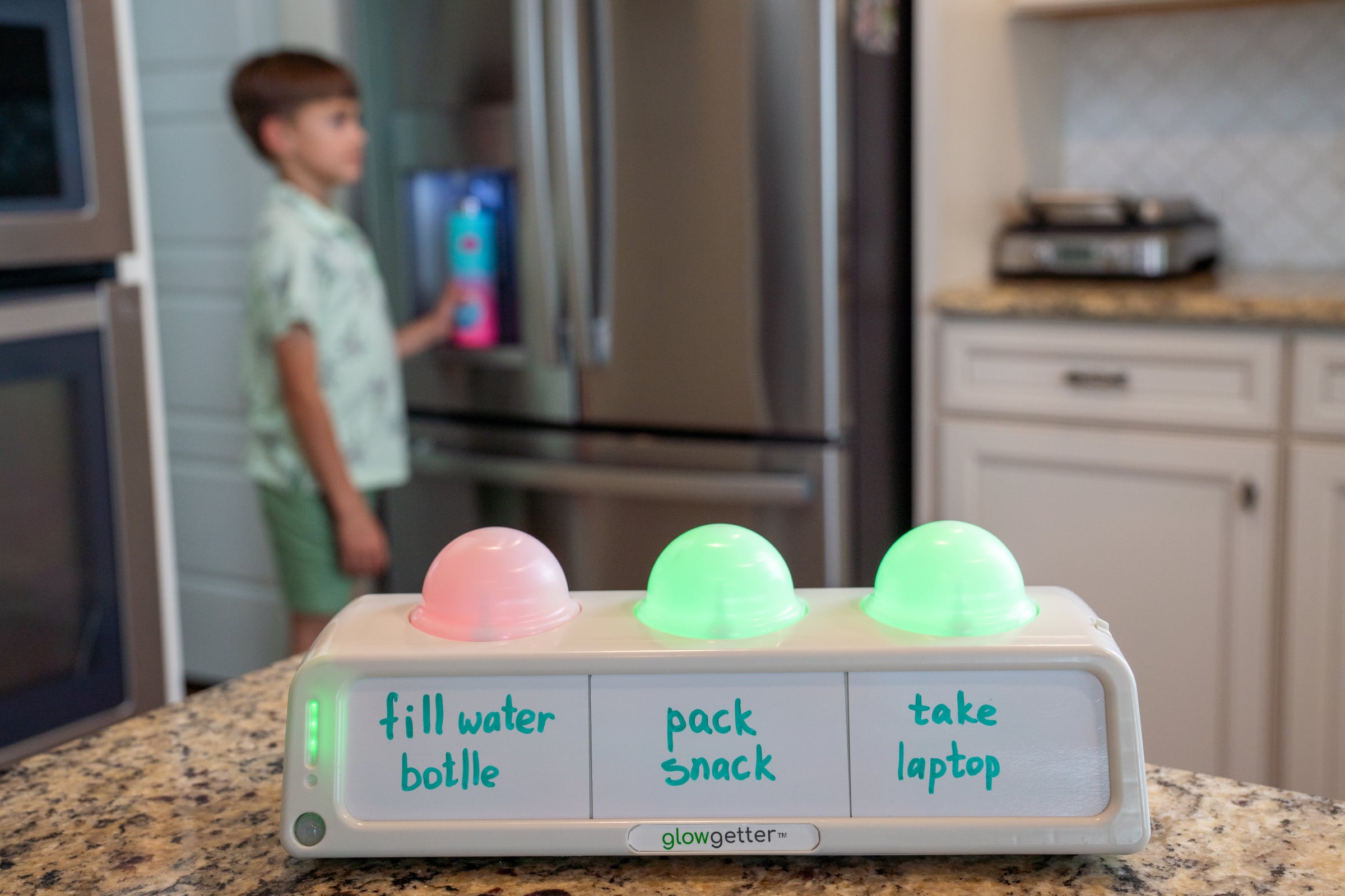 Glowgetter starter kit with device, dry-erase task cards, marker, and cleaning cloth.